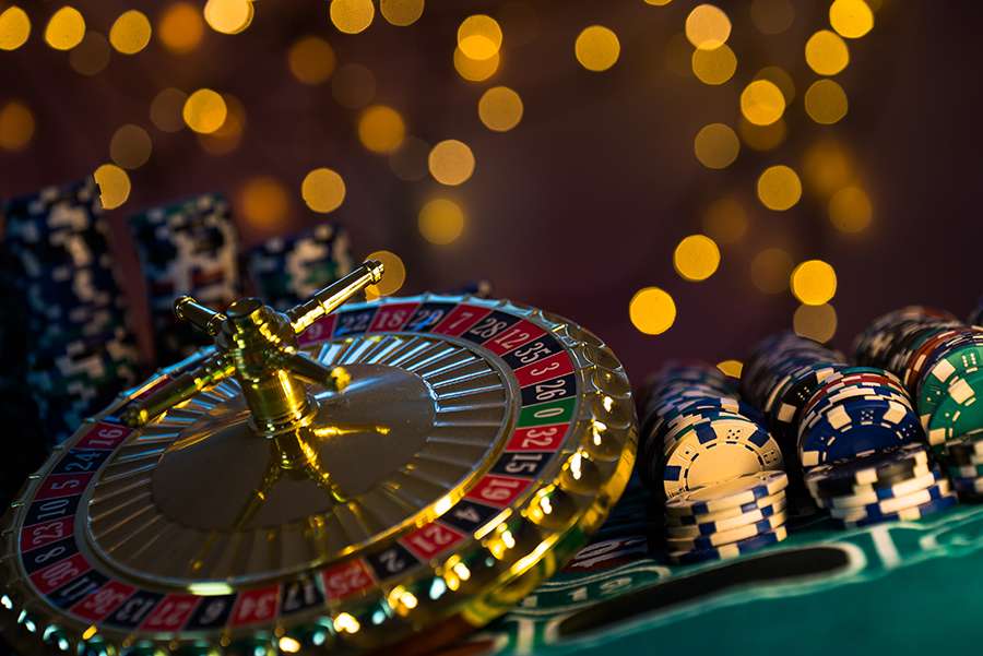 Casino theme. High contrast image of casino roulette, and poker